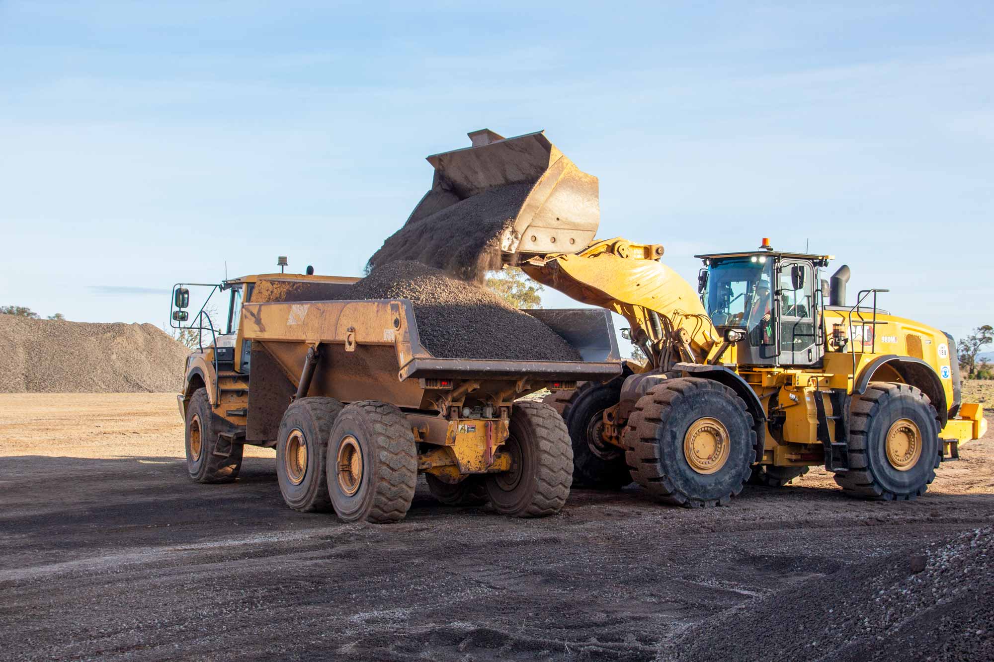 Image of machinery loading truck with crushed rock