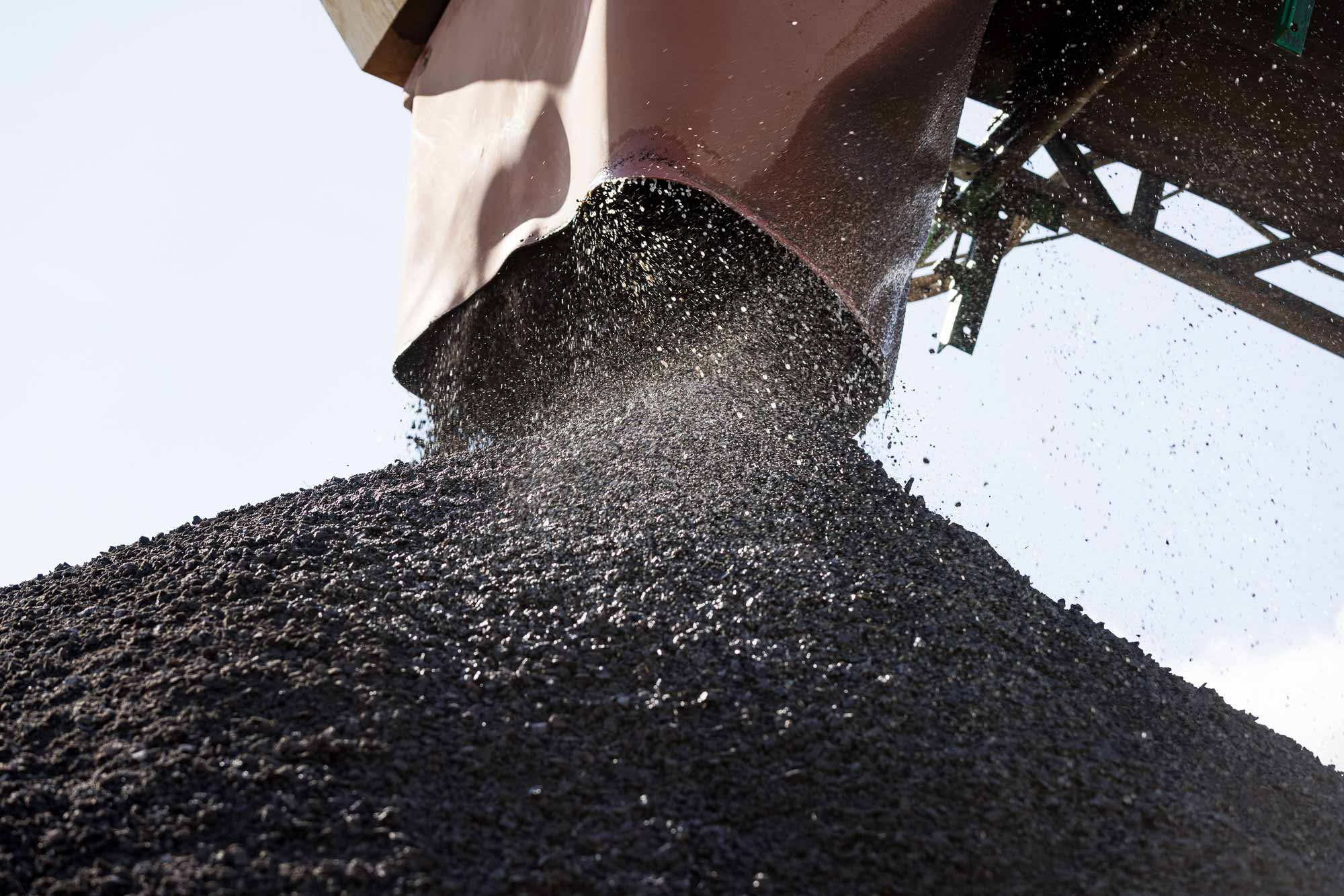 Image of equipment pouring crushed rock